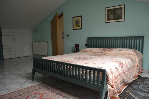 a bedroom with a large bed with a blanket on it at Casa Margubbio in Ameglia