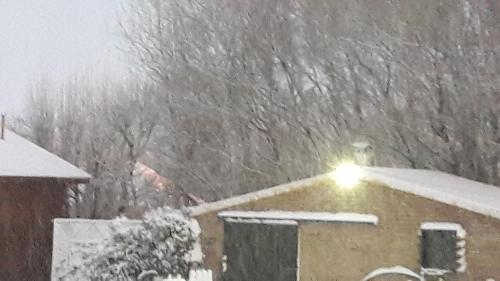 a snow storm with a light on top of a house at Cabañas Oyikil in El Calafate
