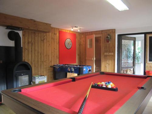 a red pool table in a room with a kitchen at Holiday home in Cachrov - Böhmerwald 35500 in Čachrov