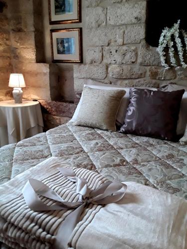 a large white bed with pillows in a bedroom at Case Brizi Assisi in Assisi