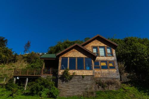 a house sitting on top of a hill at Cabañas Alcamar in Castro