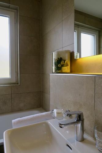 a bathroom with a sink and a mirror at Zurich Furnished Homes in Zürich