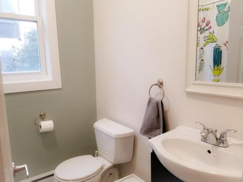 a bathroom with a white toilet and a sink at Ottawa Stay Downtown Suites in Ottawa