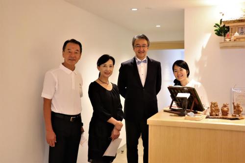 a group of people standing in front of a counter at Auberge AZABU in Kyoto