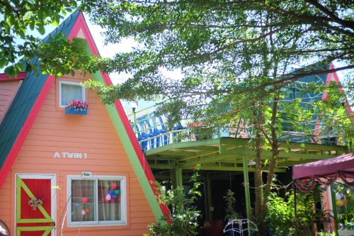 a colorful house with a balcony in front of it at A Houses Homestay in Nakhon Ratchasima