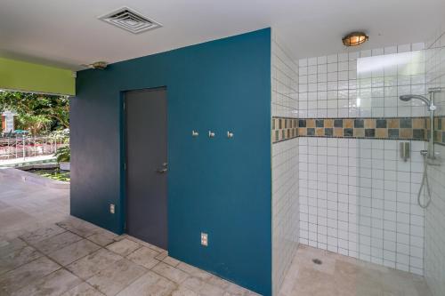 a bathroom with a blue door and white tiles at BOND ESTATE LUXURY ACCOMMODATION in Christchurch