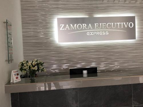 a sign for a zambora electronic store on a wall at ZAMORA EJECUTIVO EXPRESS in Zamora de Hidalgo