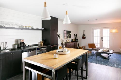 a kitchen and dining room with a wooden table at Bode Nashville in Nashville