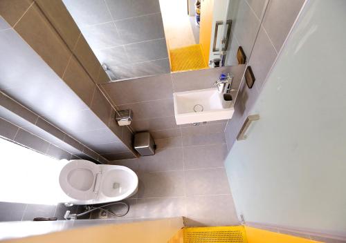 a bathroom with a sink and a toilet and a mirror at Hanoi Banana Hostel in Hanoi