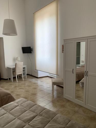 a bedroom with a bed and a table with a chair at Istituto SS Salvatore in Orvieto