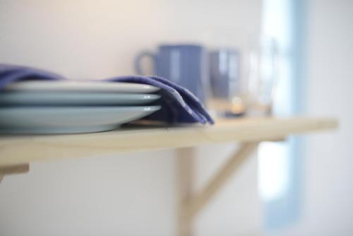 a table with a plate and a napkin on it at Villa Maria Apartments in Akrotiri