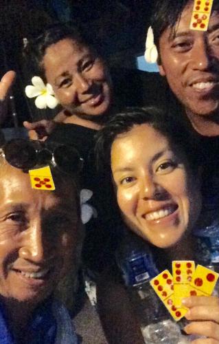 a group of people posing for a picture with playing cards at Apollo Hostel in Lovina