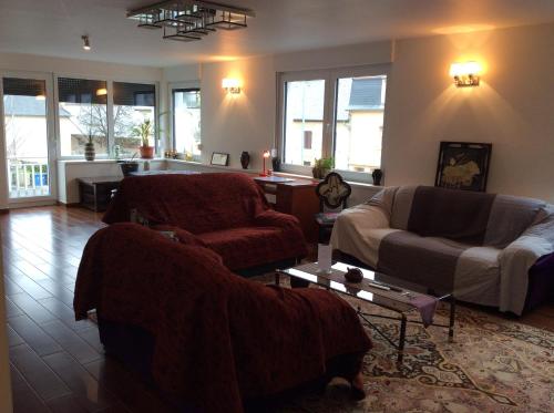 a living room with two chairs and a couch at Sanhe in Rollingen