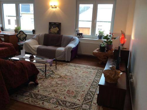 a living room with a couch and a table at Sanhe in Rollingen