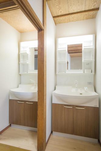 a bathroom with two sinks and a mirror at woodon in Osaka