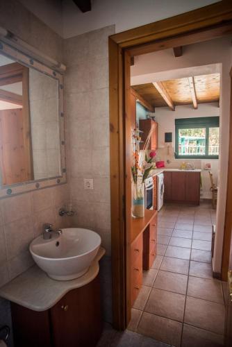 a bathroom with a sink and a kitchen at Villa Afou in Afráta