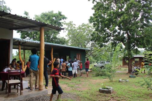 a group of people standing outside of a building at Wilpattu Holiday Home in Nochchiyagama
