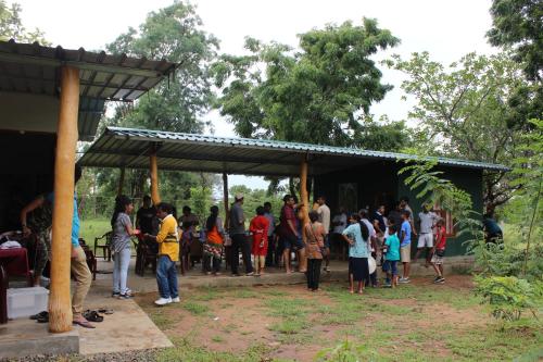 a group of people standing in a pavilion at Wilpattu Holiday Home in Nochchiyagama