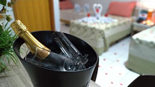 a champagne bottle in a black container on a table at Hotel CTC in Caldas Novas