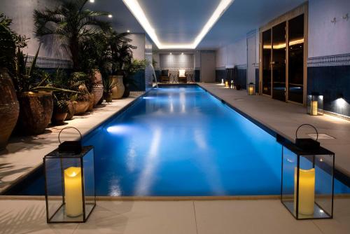 a large pool with blue water in a building at Hôtel Montecristo in Paris