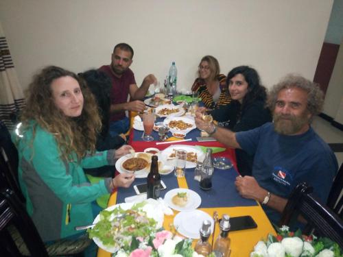 a group of people sitting at a table eating food at Honey Land Hotel Lalibela in Lalībela