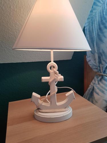 a toy ship on a table with a lamp at HR Townhouse Honigbach in Coesfeld