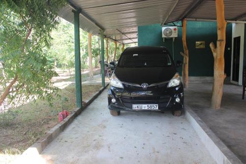 a small car parked inside of a building at Wilpattu Holiday Home in Nochchiyagama