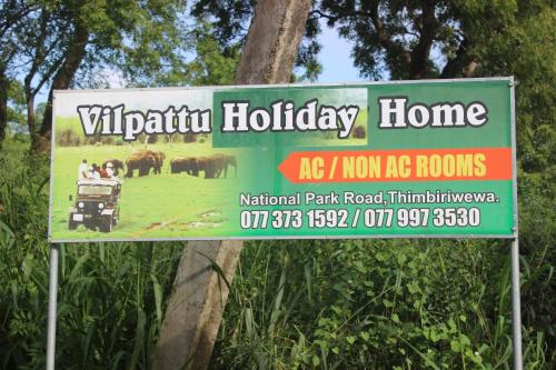 una señal para una casa de vida silvestre en un parque en Wilpattu Holiday Home, en Nochchiyagama