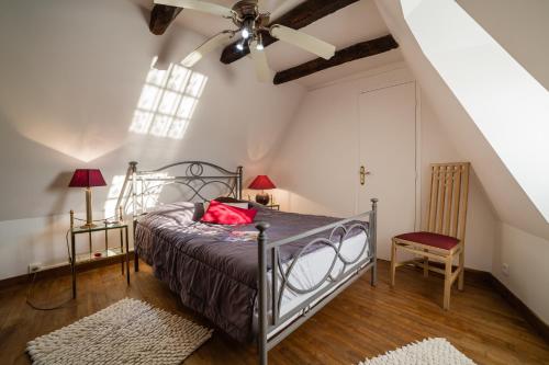 - une chambre avec un lit et un ventilateur de plafond dans l'établissement Au coeur de Beynac, maison authentique avec vue magique sur la rivière, à Beynac-et-Cazenac