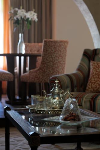 a coffee table with a tea pot and glasses on it at Souq Waqif Boutique Hotels - Tivoli in Doha