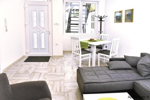 a living room with a couch and a table at Vajda Apartments in Novi Sad