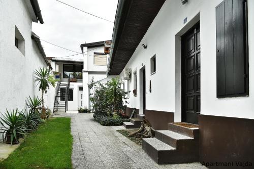 a courtyard of a house with stairs leading to a door at Vajda Apartments in Novi Sad