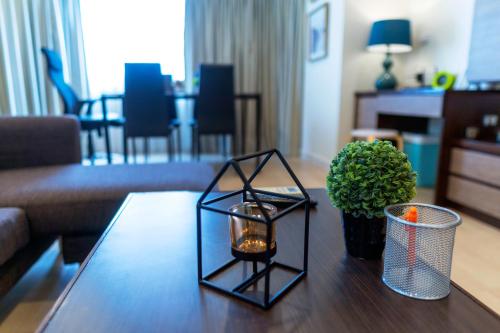 a living room with a table with a candle on it at ARMO Nimman in Chiang Mai