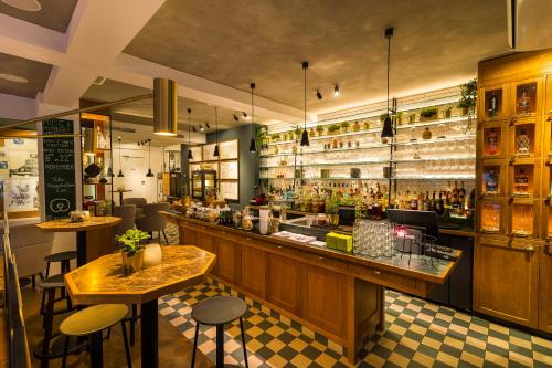 a restaurant with a bar and some tables and chairs at Green Hotel in Genk