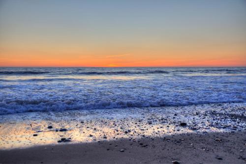 an image of the ocean at sunset at Enlli Fach cabin sleep's 2 adults and 2 children 2 dogs welcome not suitable for contract workers due to parking height restrictions in Borth