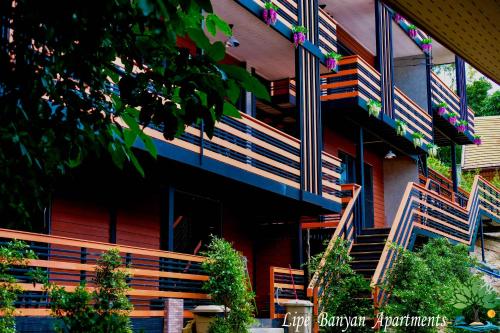 a building with wooden stairs and a stair case at Lipe Banyan Apartments in Ko Lipe