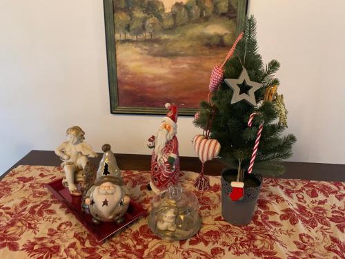 a table topped with christmas items and a christmas tree at Pensiunea Ghiocelul in Avrig