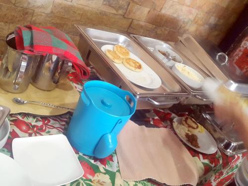 a table topped with plates of food on a table at Hotel Villa Playa Grande in Playa Grande