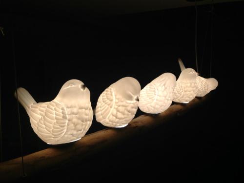a group of three ceramic birds on a shelf at CasaNova in Bad Windsheim