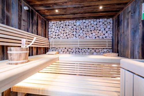 an empty sauna with wooden walls and wood floors at Gasteg Living in Maria Alm am Steinernen Meer