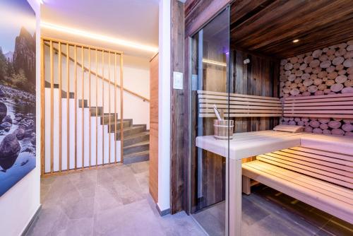 a sauna with wooden walls and stairs in a house at Gasteg Living in Maria Alm am Steinernen Meer