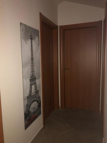 a picture of the eiffel tower next to a door at Il Pozzo Country House in Collescipoli