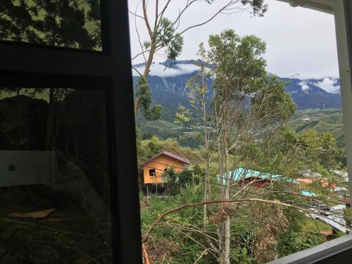 a window view of a mountain view from a house at Azrien Homestay Kundasang in Kundasang