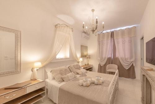 En eller flere senge i et værelse på QuattroCuori Boutique Hotel & Spa