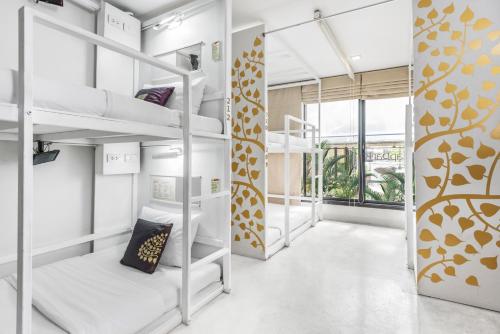 a dorm room with bunk beds in it at Nappark Hostel @Khao San in Bangkok