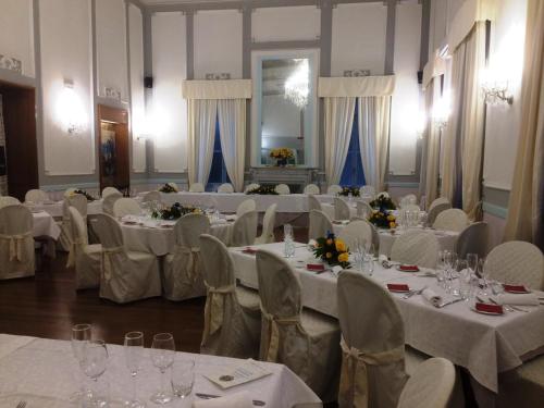 a room filled with tables and chairs with white tablecloths at Grand Hotel & des Anglais Spa in Sanremo