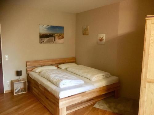 a bed in a corner of a room at Lord Nelson Apartment 13 in Cuxhaven