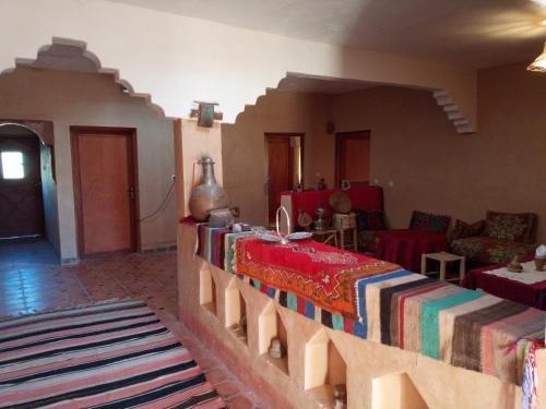 a living room with a bed and a couch at Dar Zara in Ouarzazate