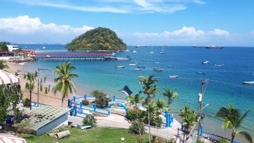 a view of a beach with boats in the water at Hotel Vereda Tropical in Taboga