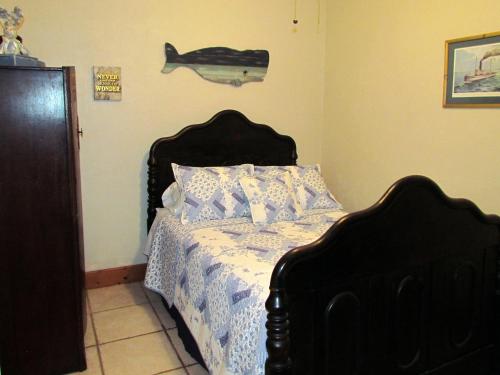 a bedroom with a bed and a fish on the wall at The Yearling Cabins in Cross Creek